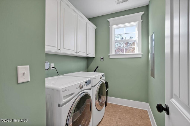 washroom with washer and clothes dryer, light tile patterned floors, and cabinets