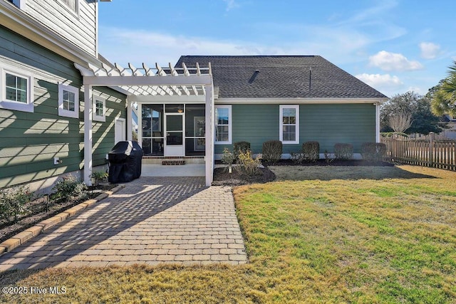 back of property featuring a yard, a pergola, and a patio