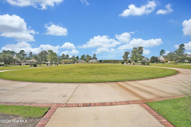 view of property's community with a yard