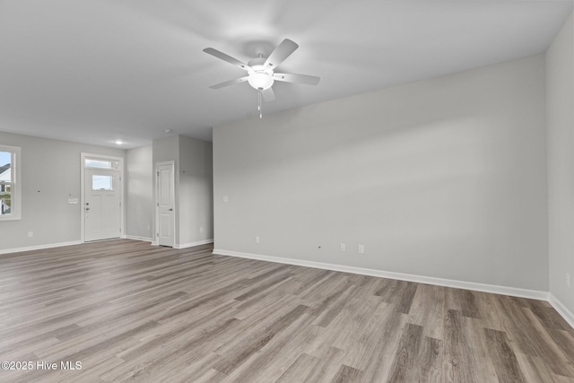 unfurnished living room featuring ceiling fan and light hardwood / wood-style flooring