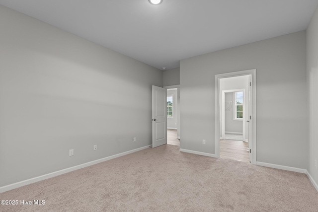 unfurnished bedroom featuring light colored carpet