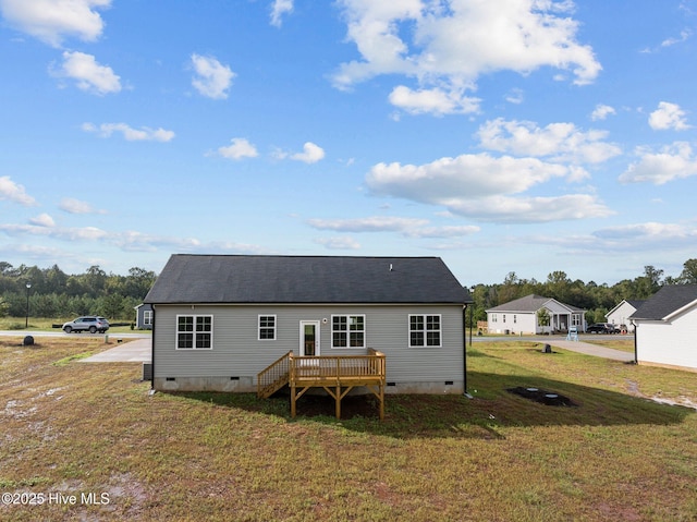 back of house with a yard and a wooden deck