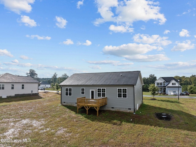 rear view of property with a yard and a wooden deck