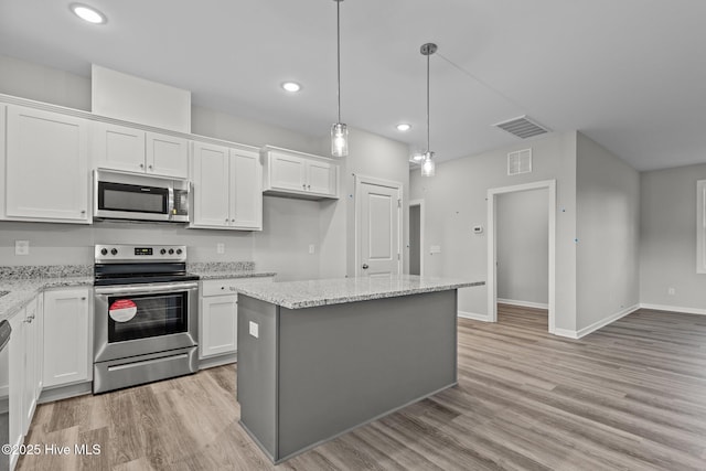 kitchen featuring white cabinetry, a kitchen island, stainless steel appliances, and decorative light fixtures