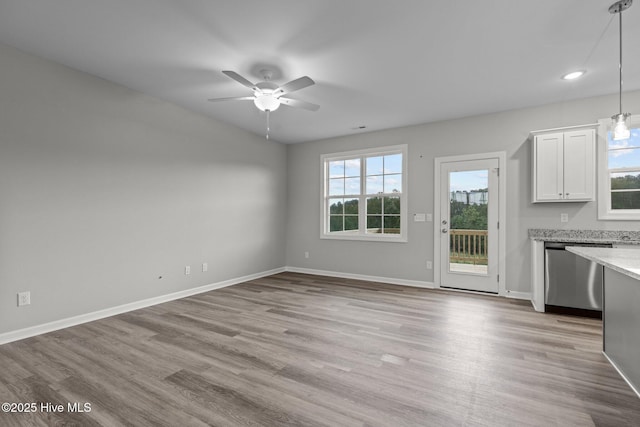 unfurnished dining area featuring light hardwood / wood-style flooring and ceiling fan