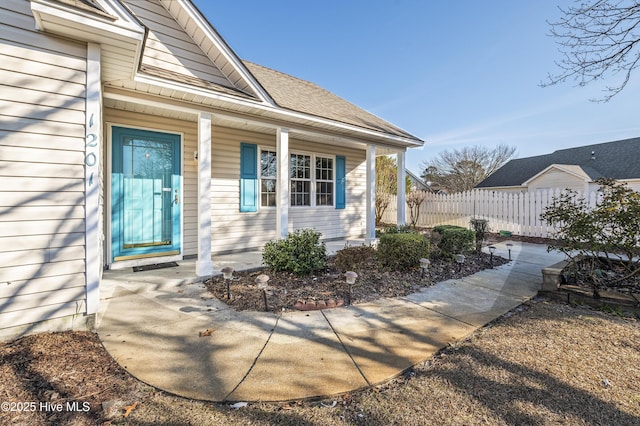 view of exterior entry featuring covered porch