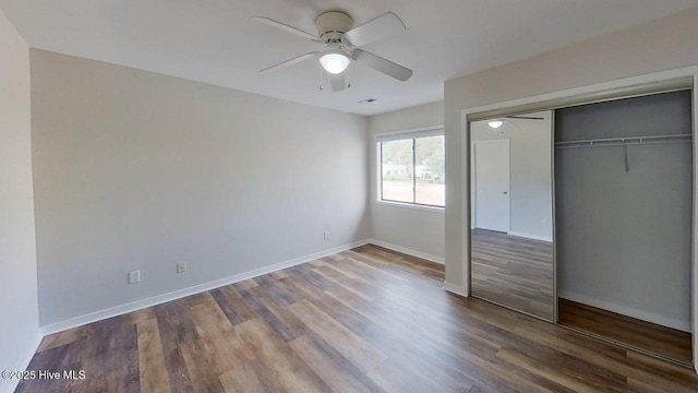 unfurnished bedroom featuring hardwood / wood-style floors, ceiling fan, and a closet