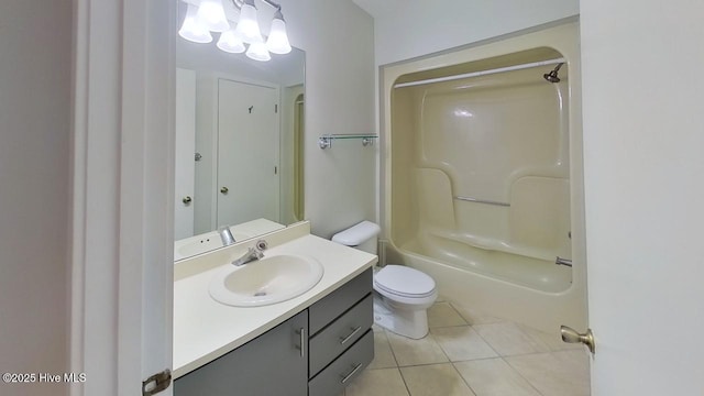 full bathroom featuring tile patterned floors, vanity, toilet, and washtub / shower combination