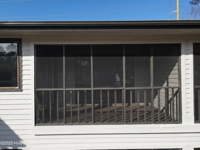 view of side of property with a sunroom