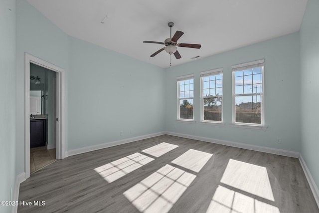 spare room featuring ceiling fan and dark wood-type flooring