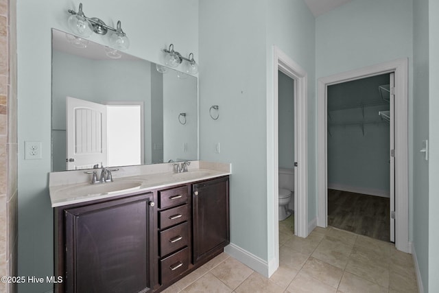 bathroom featuring tile patterned flooring, vanity, and toilet