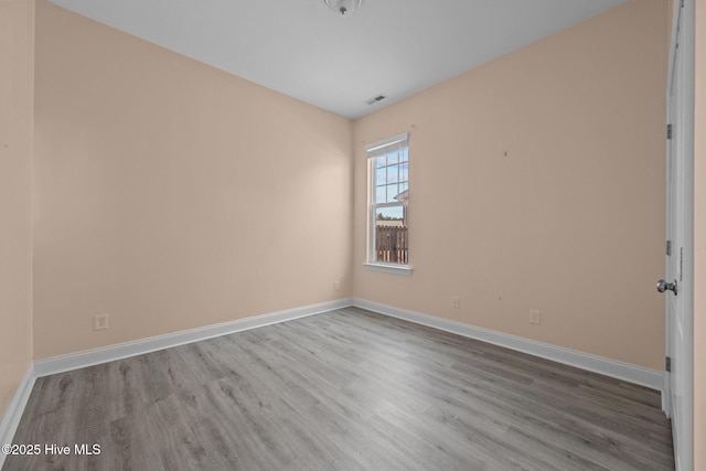 empty room with light hardwood / wood-style floors