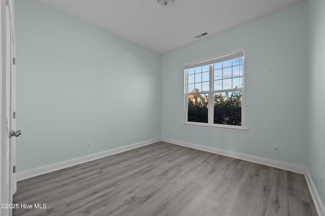 unfurnished room with light hardwood / wood-style floors