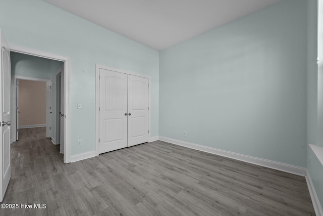 unfurnished bedroom with light hardwood / wood-style floors and a closet