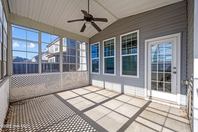 unfurnished sunroom with vaulted ceiling and ceiling fan