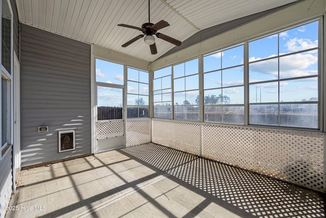 unfurnished sunroom featuring ceiling fan, a water view, and lofted ceiling