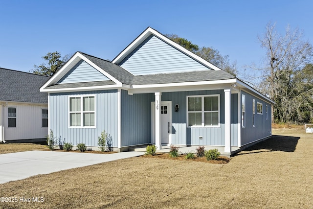 view of front of property with a front yard and covered porch