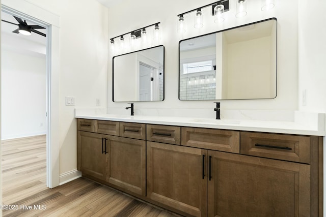 bathroom featuring hardwood / wood-style floors, ceiling fan, and vanity