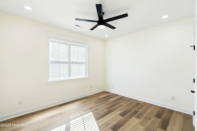 spare room featuring ceiling fan and light wood-type flooring