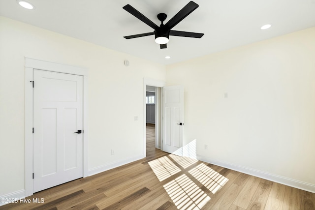 unfurnished bedroom featuring a closet, ceiling fan, and light hardwood / wood-style flooring