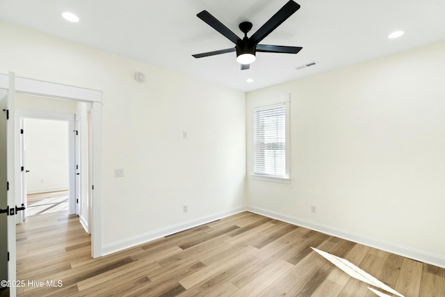 empty room with ceiling fan and light wood-type flooring