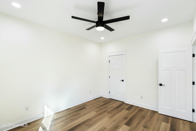 spare room featuring hardwood / wood-style floors and ceiling fan