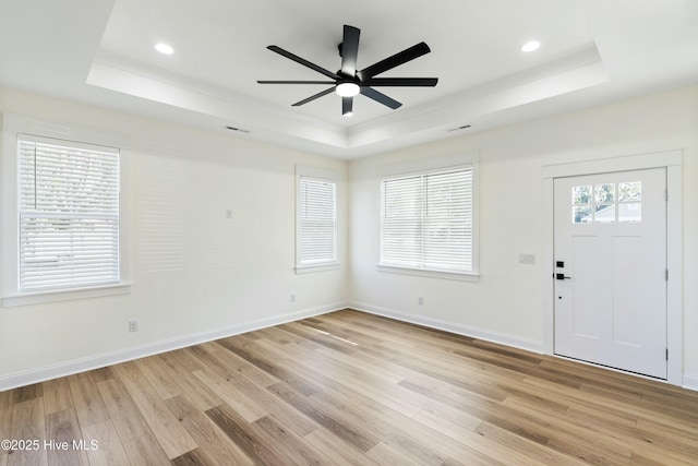 entrance foyer featuring light wood-type flooring and a raised ceiling