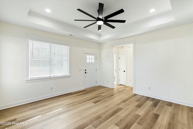 interior space featuring plenty of natural light and a raised ceiling