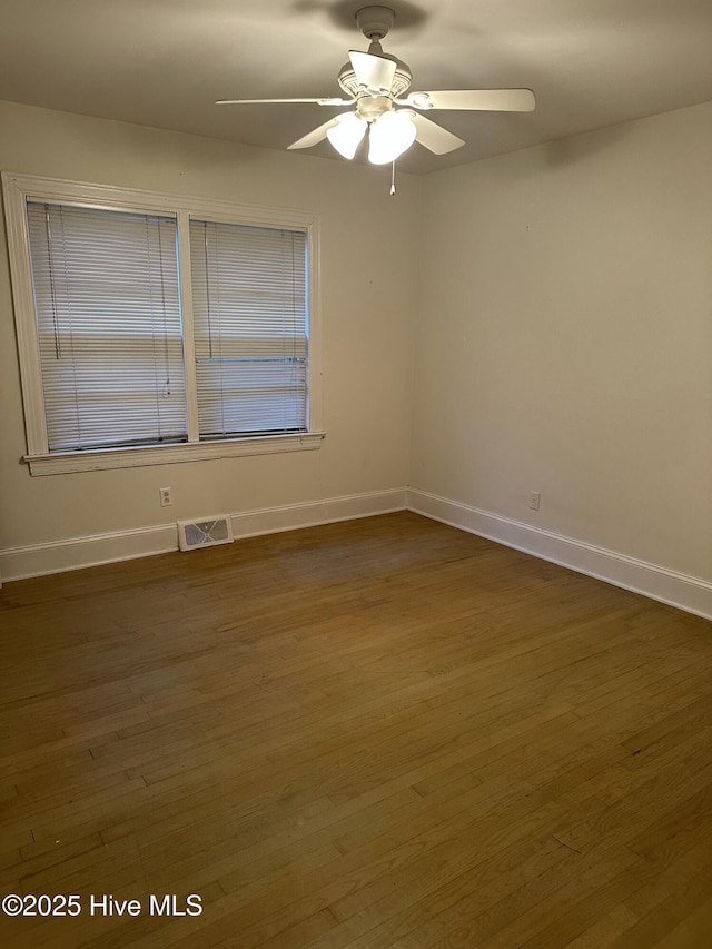 unfurnished room with ceiling fan and dark hardwood / wood-style floors