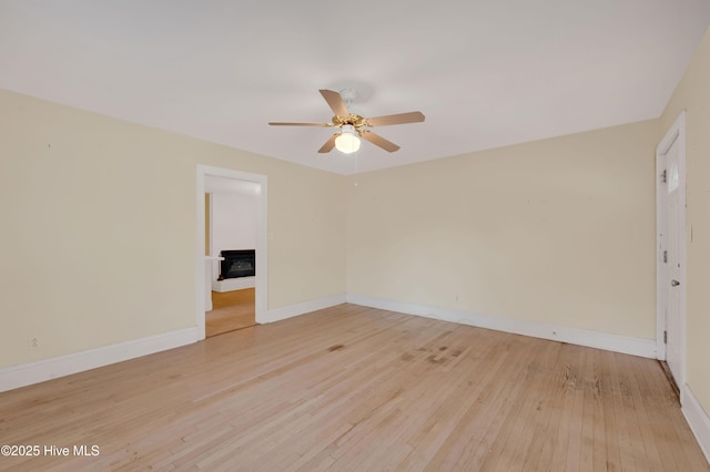 unfurnished room with ceiling fan and light wood-type flooring