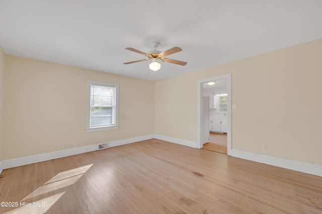 unfurnished room featuring ceiling fan and light wood-type flooring