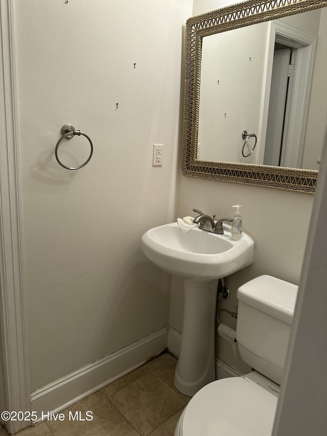 bathroom featuring toilet and tile patterned floors