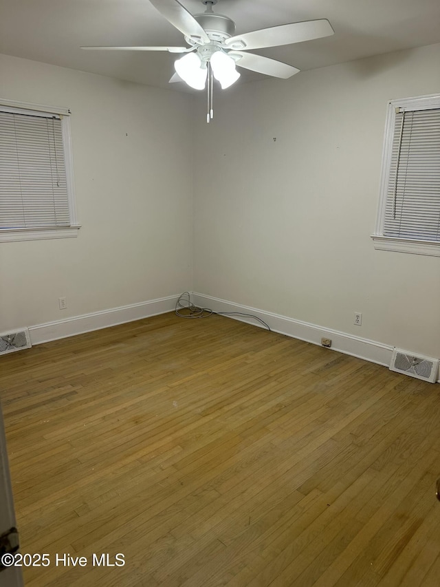 empty room featuring ceiling fan and hardwood / wood-style floors