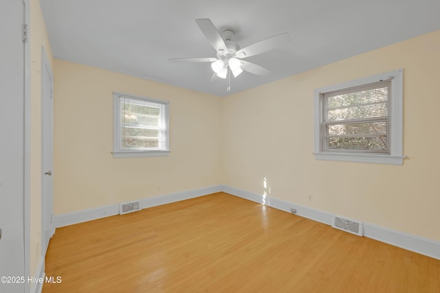 empty room with ceiling fan and wood-type flooring