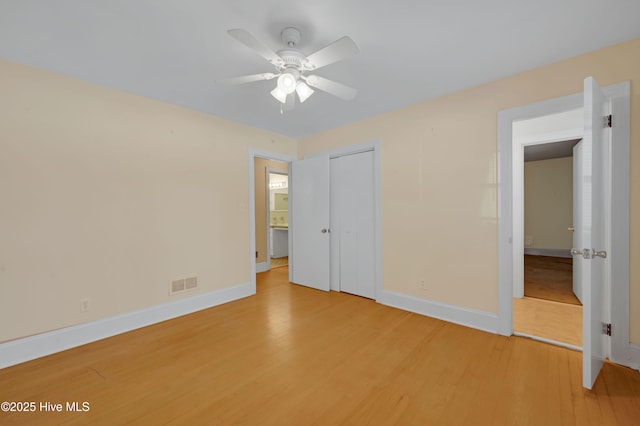 unfurnished bedroom featuring wood-type flooring and ceiling fan