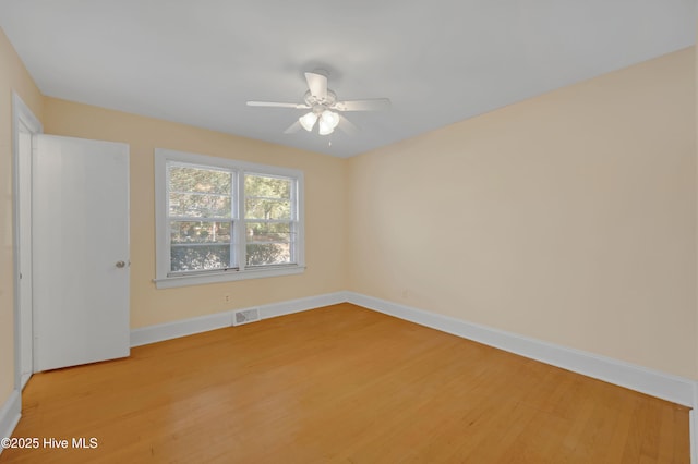 empty room featuring hardwood / wood-style floors and ceiling fan