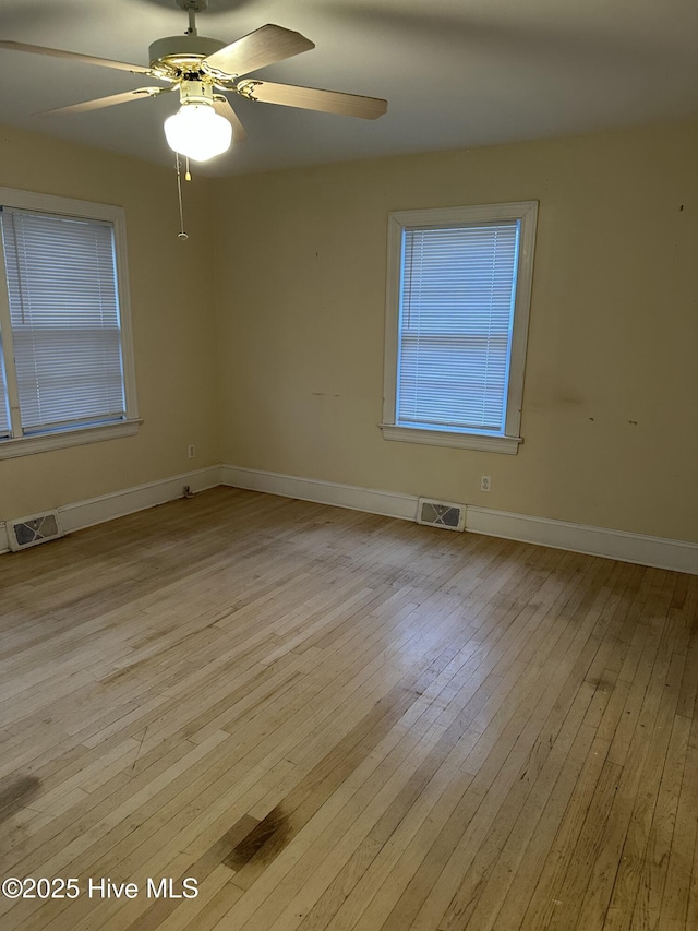 spare room featuring ceiling fan and light hardwood / wood-style flooring