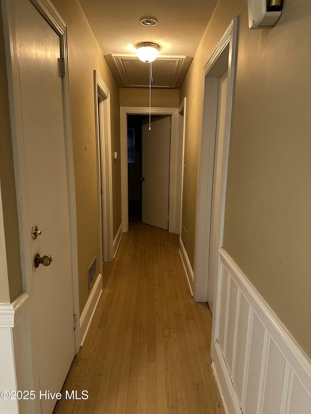 corridor with light hardwood / wood-style floors