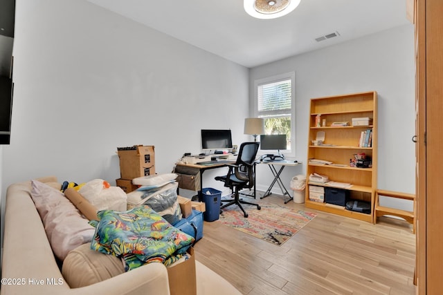 office space with visible vents and wood finished floors