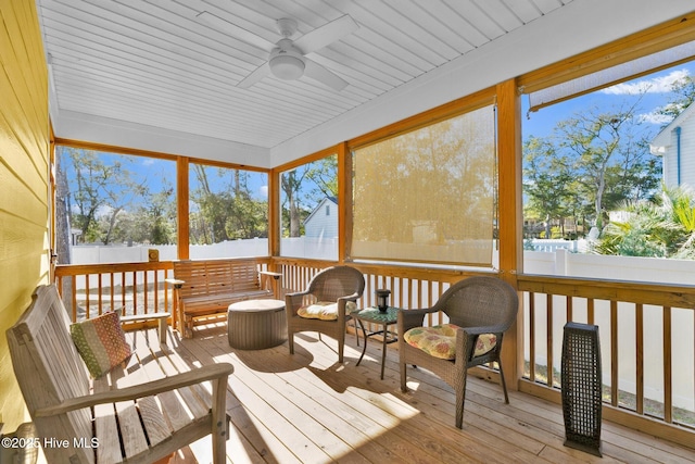 sunroom / solarium featuring ceiling fan