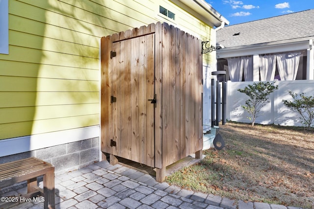 view of outbuilding featuring fence