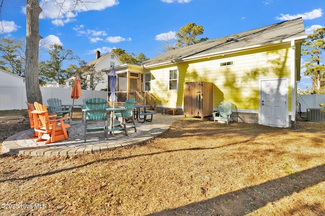 back of property featuring a patio area, fence, cooling unit, and a sunroom