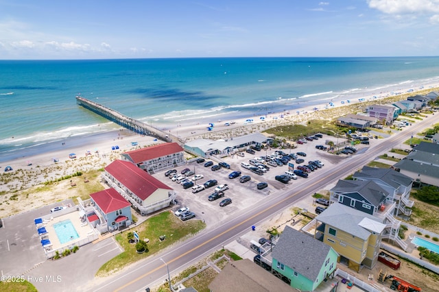 drone / aerial view featuring a view of the beach and a water view