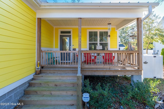 property entrance with covered porch