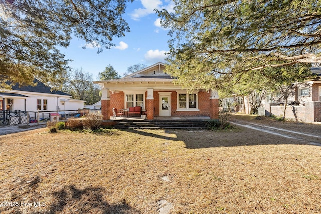 view of front of house featuring a porch and a front lawn