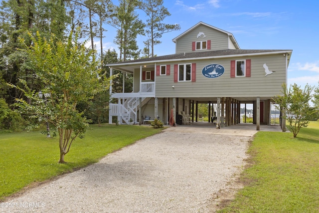 coastal home featuring a carport and a front yard