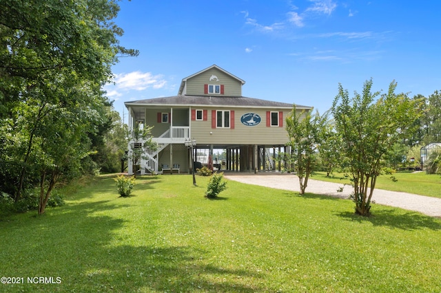 view of front facade with a carport, covered porch, and a front yard