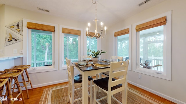 dining room featuring a chandelier and light hardwood / wood-style flooring