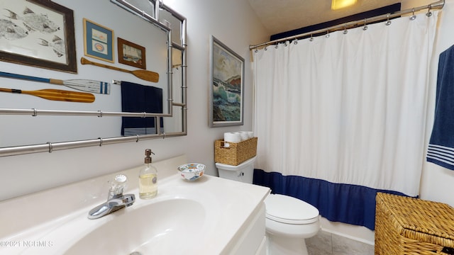 bathroom featuring sink, a shower with shower curtain, and toilet