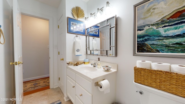 bathroom featuring tile patterned flooring, vanity, and toilet